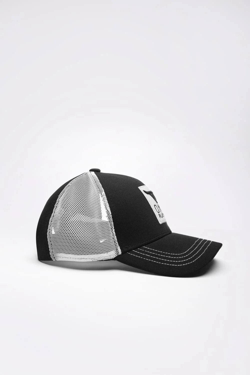Unisex Black & White Trucker cap, has a visor by One Player